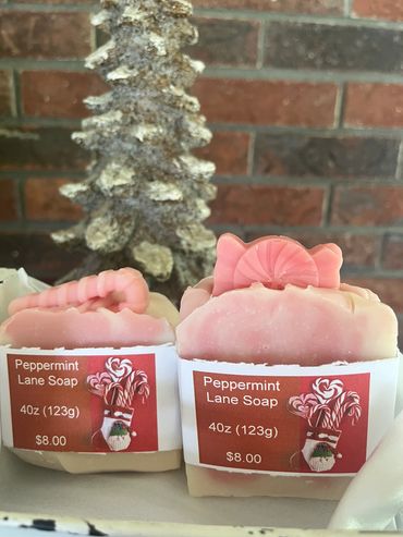 Two bars of peppermint lane soap with candy-shaped decorations and price tags.
