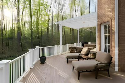 Spacious porch with comfortable lounge chairs and forest view.
