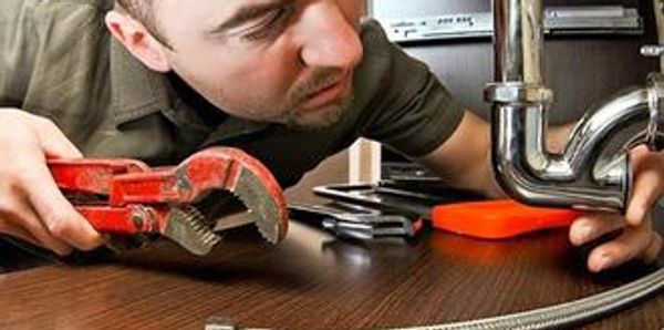 a man carefully doing the plumbing job