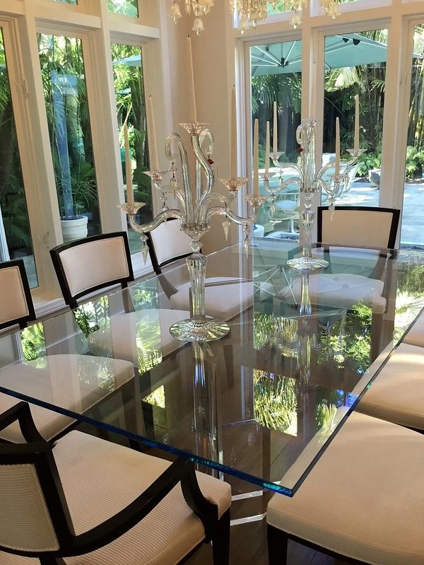 Glass dining room table, cream colored chairs.