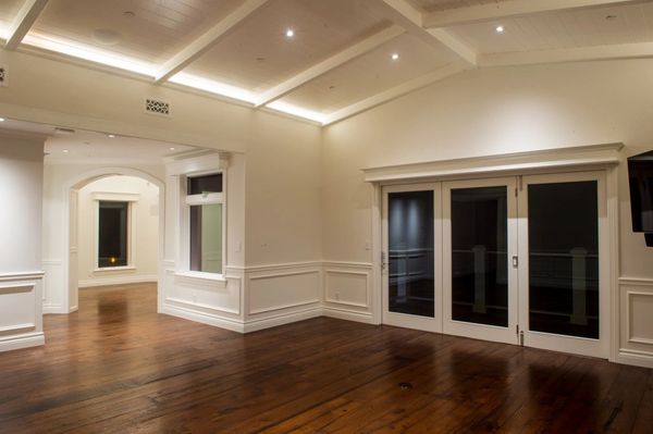 Big open room with hardwood floors and french doors.