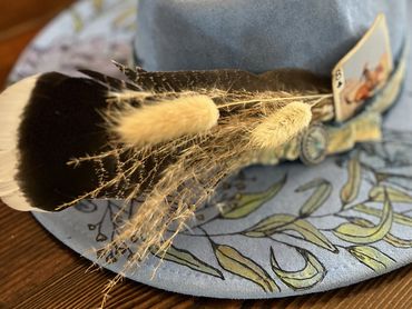 Stylish blue hat with feathers and card decoration
