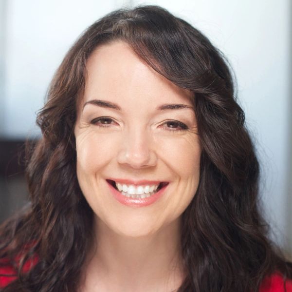 Smiling woman with long dark hair.