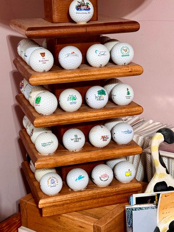 Golf ball display collection featuring logo balls gathered from courses, clubs, and events.