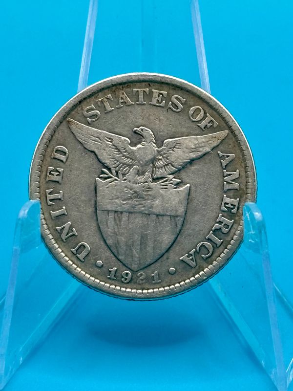 1921 Philippine 50 Centavos silver coin with Filipina figure, anvil, and Mayon Volcano.
