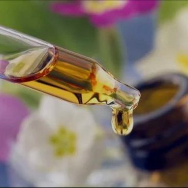 CALMIST BOTTLE AND DROPPER OF ESSENTIAL OIL AND FLOWERS