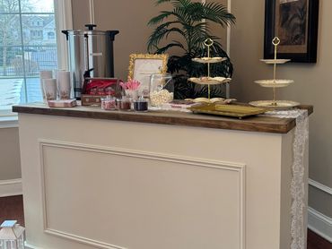 Elegant refreshment bar rental with hot chocolate setup and decorative dessert trays.