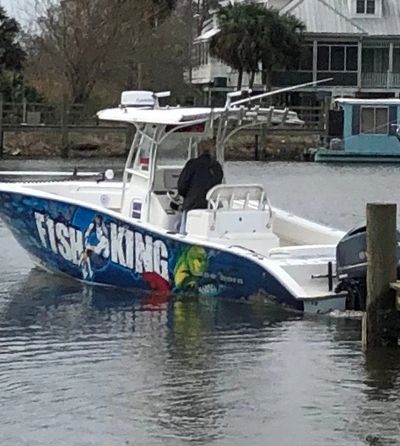 man driving a boat on the dock