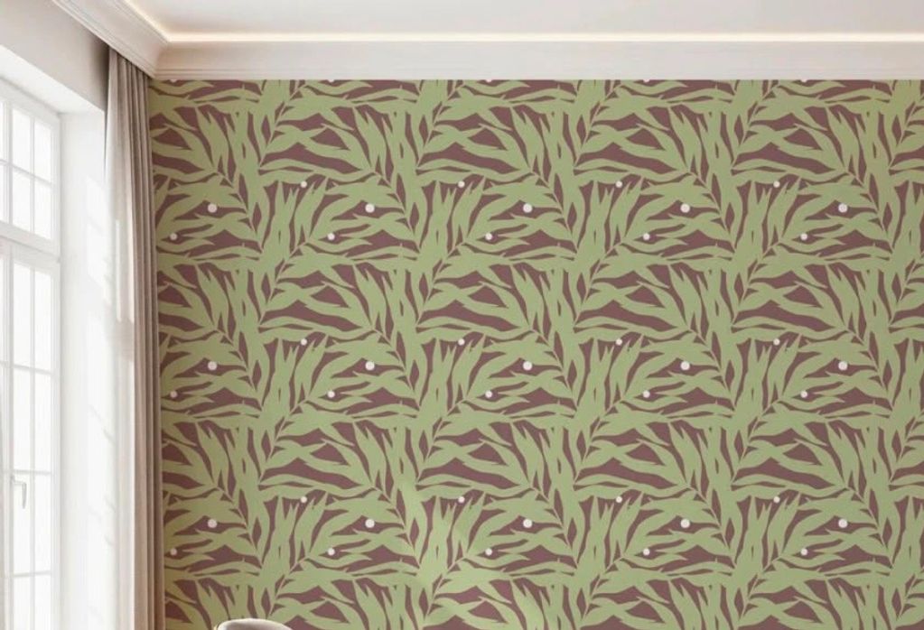 Green leafy patterned wallpaper on a room wall.