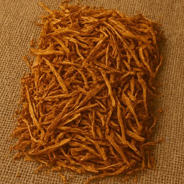 Pile of dried shredded tobacco on burlap fabric.