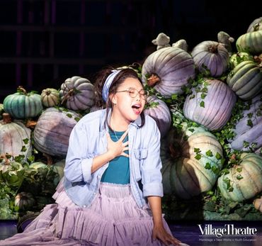 Ays in Cinderella singing in front of a pumpkin patch 
Photo by Angela Sterling