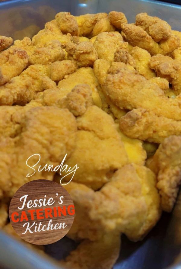 Golden fried chicken pieces ready for catering service.