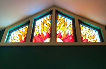 Stained glass windows with fiery sun design.
