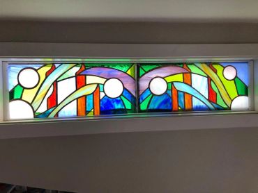 Colorful stained glass window with abstract design.