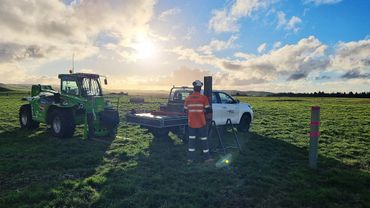 Sunset, engineer, machinery and ute undertaking pile testing on site in New Zealand