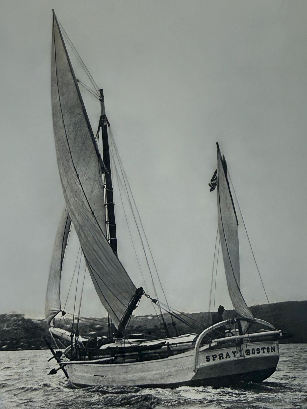 A sailboat named Spray Boston on the water.