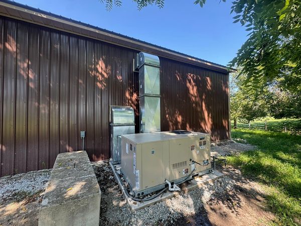 Outdoor HVAC unit next to a brown building.