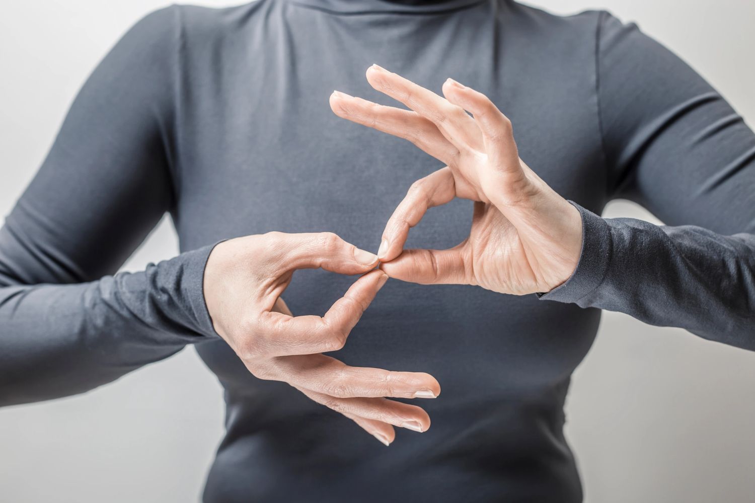Photo of an interpreter signing the word interpreter in sign language