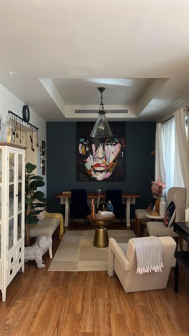 Cozy living room with modern art and comfortable seating.