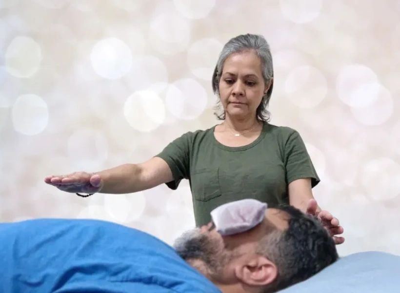 Performing Reiki therapy for mental, emotional and physical well- being.