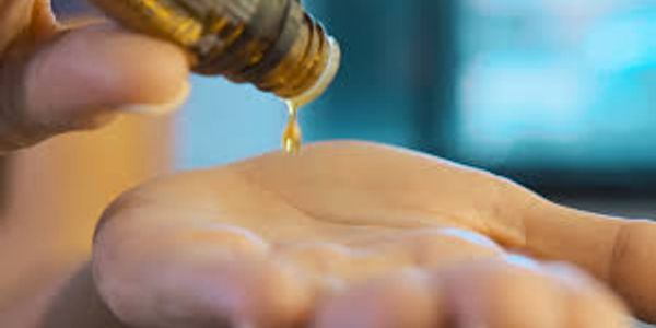 essential oils being dropped to a hand