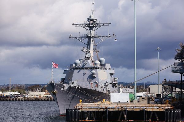 Warship docked at naval port.