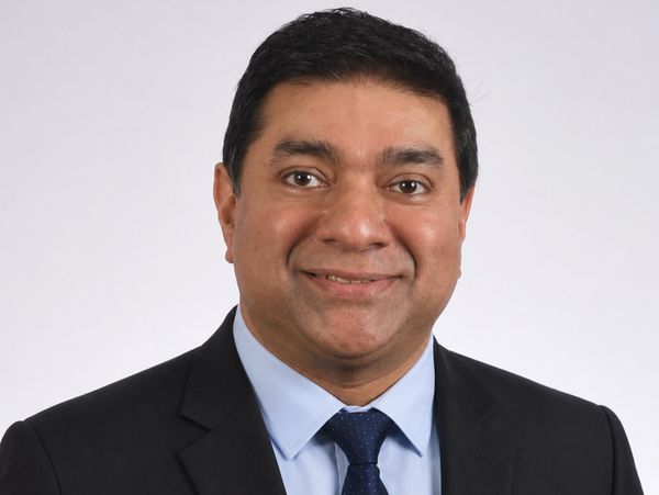 Professional portrait of a man in a suit and tie.