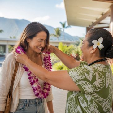 Traveler receiving a fresh orchid lei at Kahului Airport on Maui