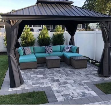 Outdoor patio with a modern sectional sofa under a gazebo.