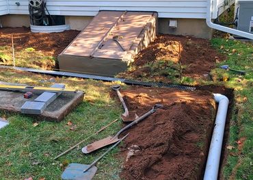 Drains and pipe layment moving water away from house