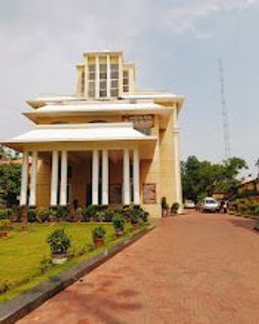 Modern building with columns and a landscaped garden.
