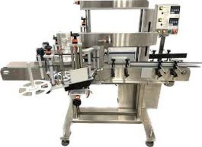 Industrial labeling machine for bottles and containers in manufacturing.