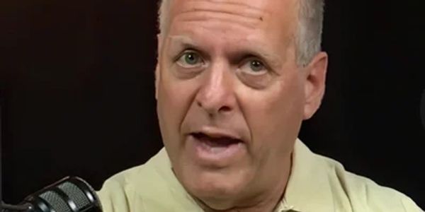 Man speaking in front of a microphone.