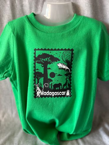 Green Madagascar-themed T-shirt with animal silhouettes and nature design.