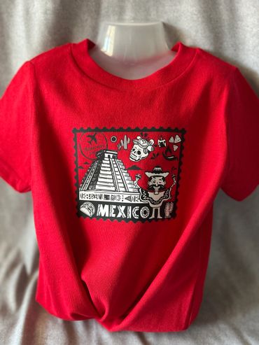Red t-shirt with Mexico-themed graphic design.