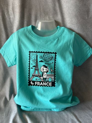 Turquoise t-shirt with a Paris-themed graphic design.