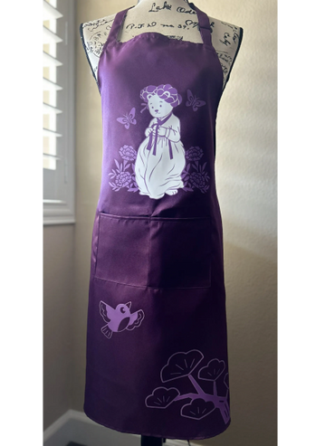Purple apron with a cute bear, butterflies, bird, and floral designs.