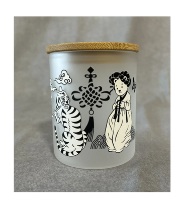 Frosted glass jar with a wooden lid, decorated with black and white Korean traditional art.