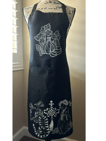 Black apron with white garlic and artistic tiger and human figure prints.