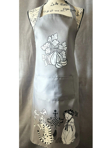 Gray apron with garlic and playful tiger and doll designs.