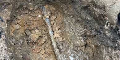 Lead pipe underground, being replaced under lead replacement scheme via trenchless impact molim