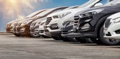 A lineup of modern SUVs parked outdoors under a partly cloudy sky.