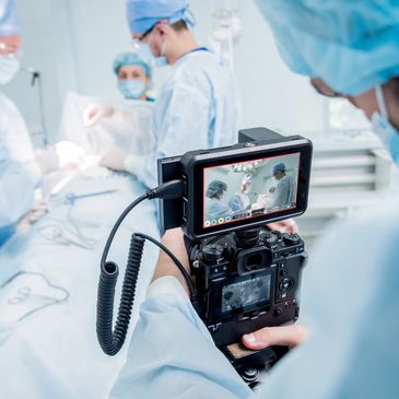 a man filming an event.