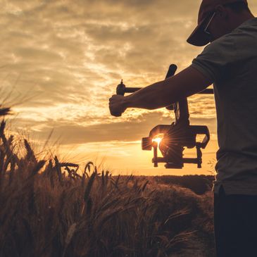 a man filming a field