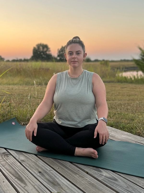 Aubrey Richardson, LPC sitting in a meditative pose