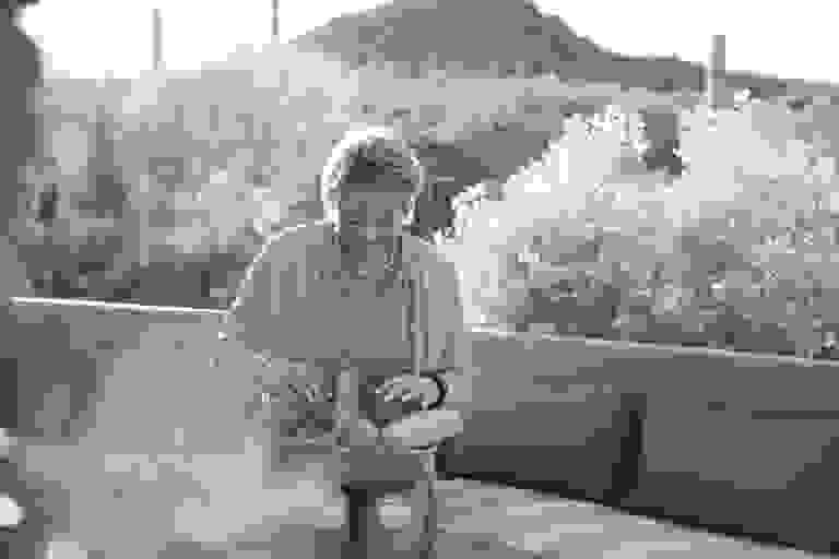 Penny with basket of vegetables on patio in Tucson.
