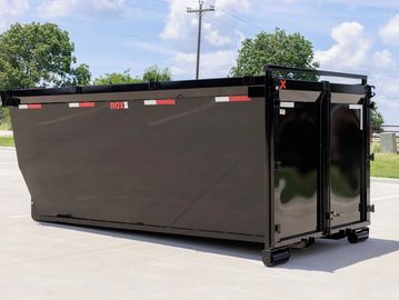 Large black metal dumpster container outdoors.