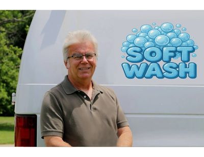Image of the owner, Terry Spivey, standing in front of his "Soft Wash" van