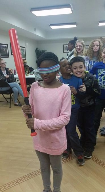 a girl being blinded for a house warming game