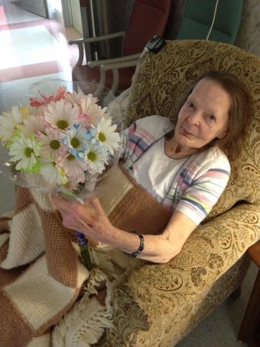 A senior woman holding a bouquet